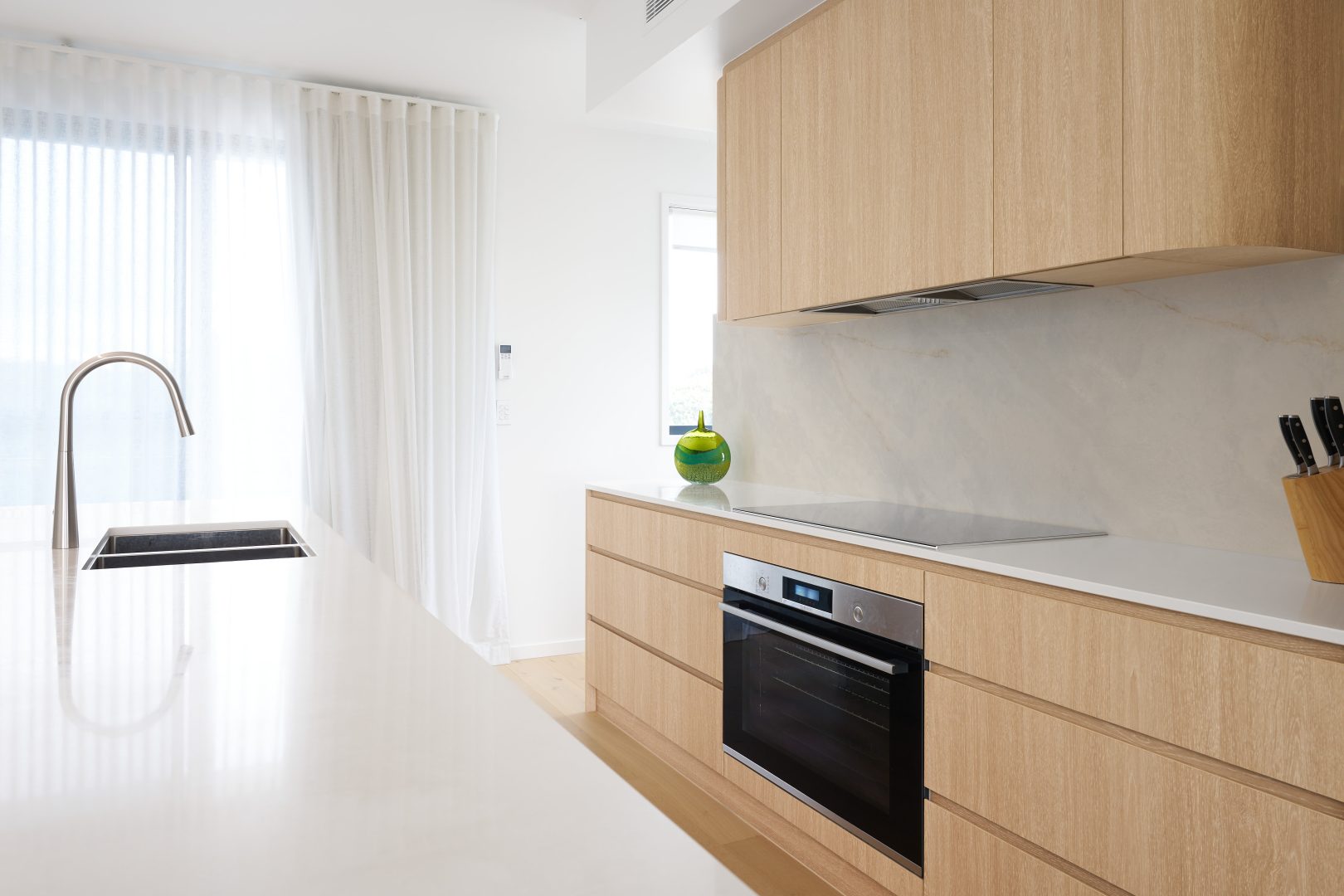 Modern kitchen with wooden cabinets and white countertops