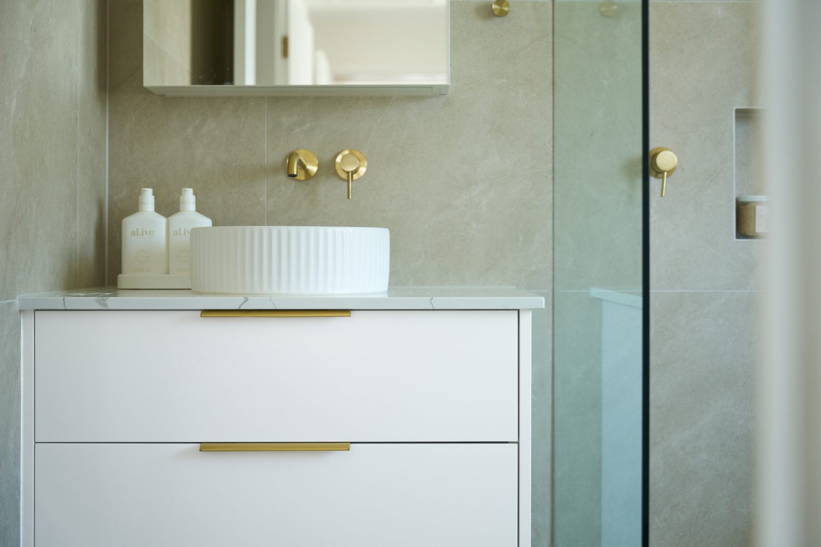 Modern bathroom with white vanity and round sink