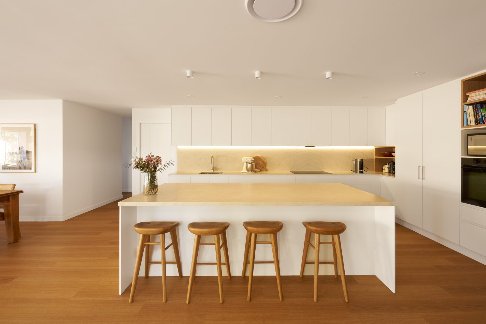 Modern kitchen with island and bar stools.