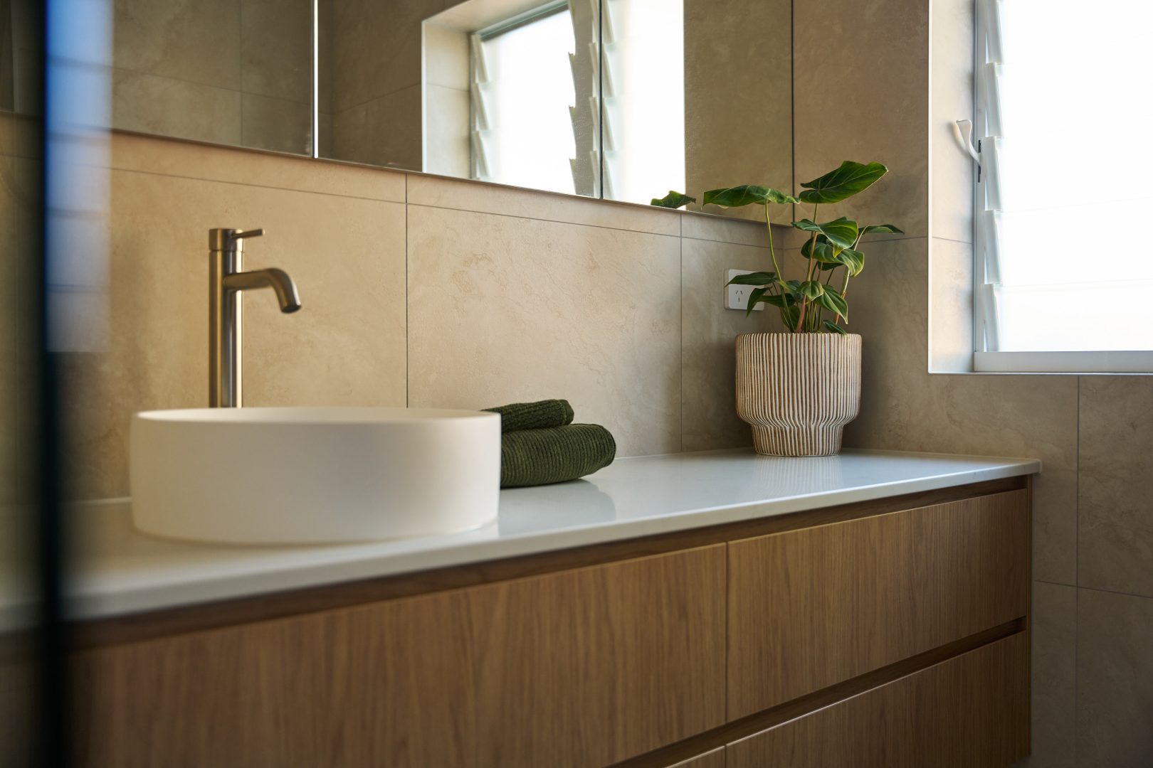 Modern bathroom with sink and plant on counter