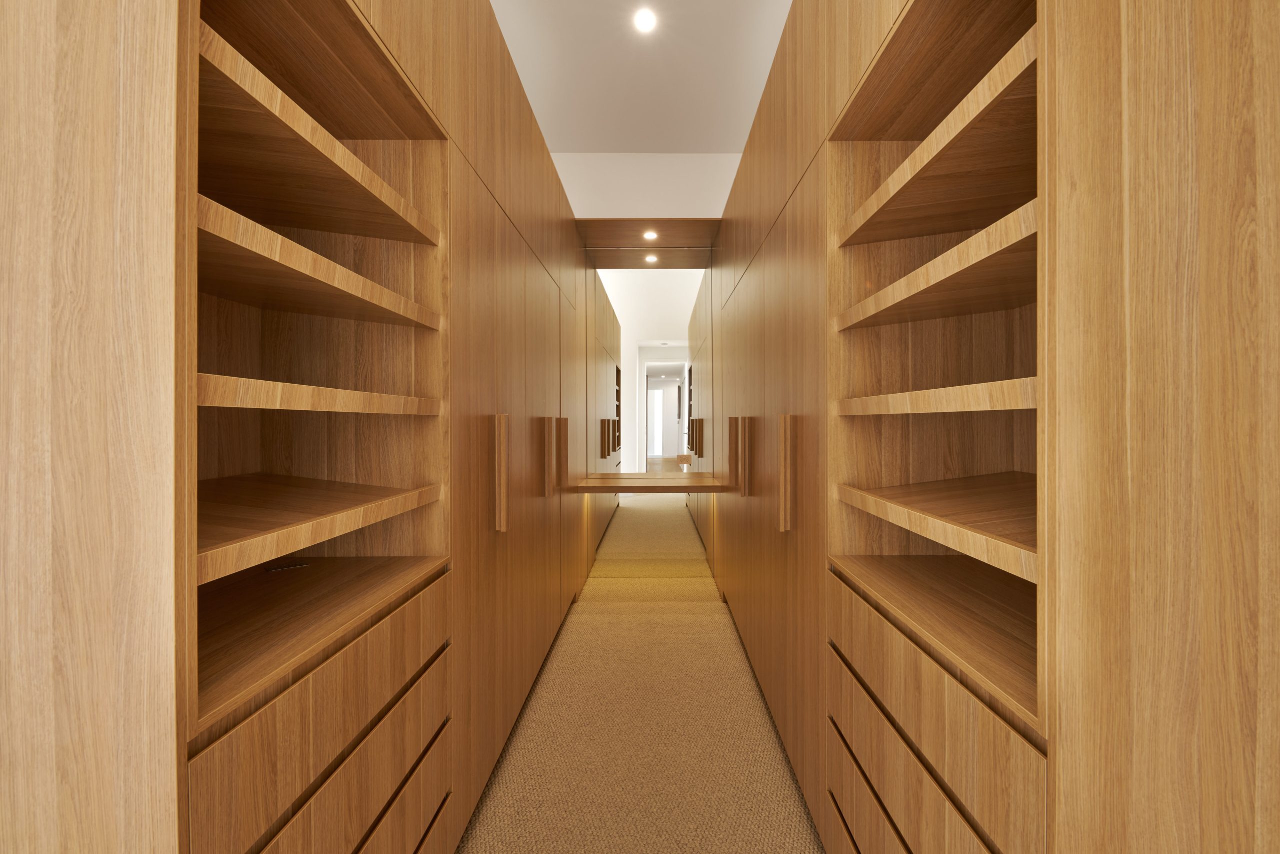 Modern wooden hallway with shelves and drawers.